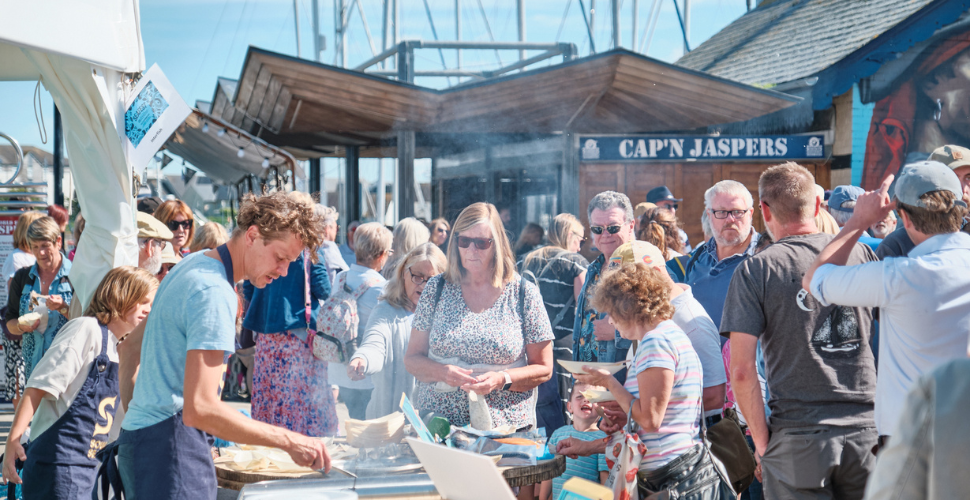 Customers surrounding a cooking stall at Seafest